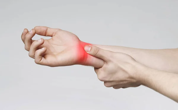 Young man suffering from carpal tunnel syndrome — Stock Photo, Image
