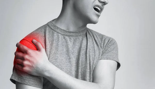 Man with inflamed shoulder zone, monochrome photo — Stock Photo, Image