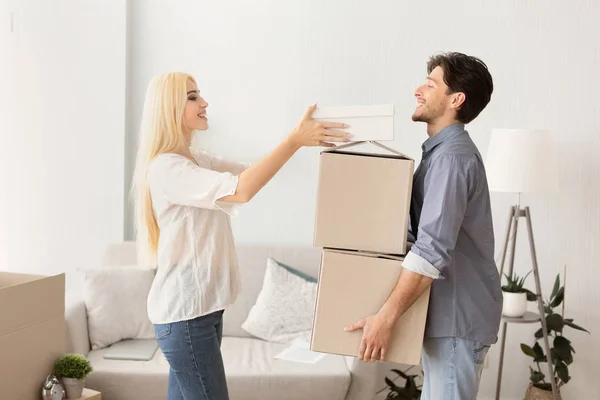 Mulher ajuda marido a embalar e transportar caixas antes de mudar de apartamento — Fotografia de Stock
