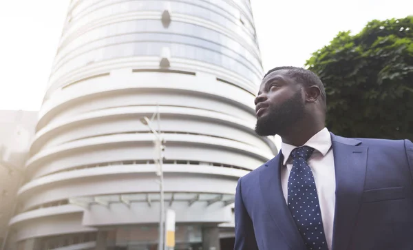 Pensive african american executive staying outdoors near business center — Stock Photo, Image