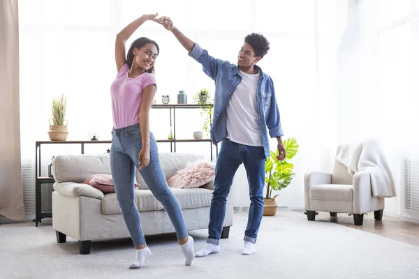 Romantic teen african american couple dancing at home