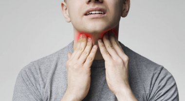 Young man pulping his inflamed neck, close up clipart