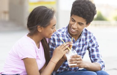 Romantik Afrikalı gençler birlikte bir kokteyl paylaşımı