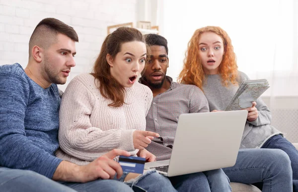 Geschokt vrienden boeken reis online met creditcard en laptop — Stockfoto