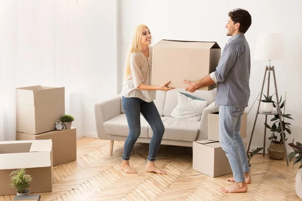 Smiling Husband and Wife Carrying Moving Box into New Flat — стоковое фото