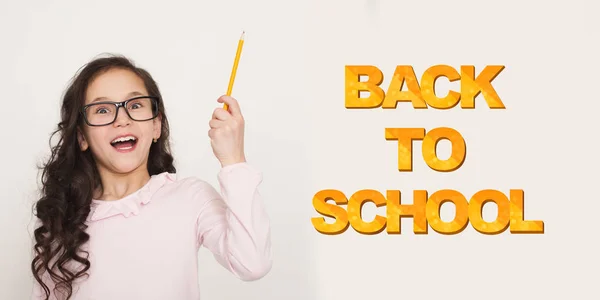 Girl in glasses holding pencil in hand and indicating on text — Stock Photo, Image