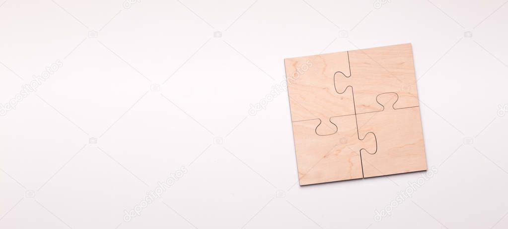 Puzzle of four wooden pieces with copy space for text