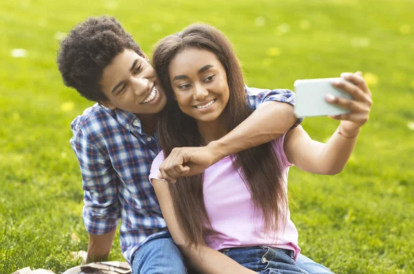 Paar tieners die selfie maken op picknick buitenshuis — Stockfoto