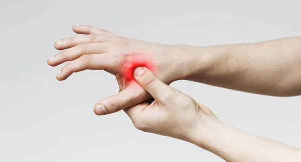 Man holding hand to spot of palm-ache, panorama — Stock Photo, Image