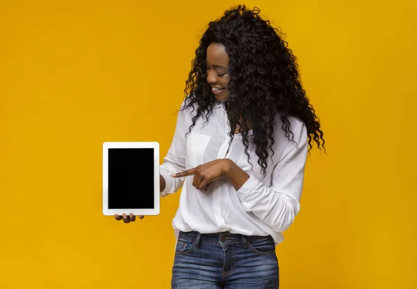 Zwarte vrouw wijzend op lege digitale tablet scherm — Stockfoto