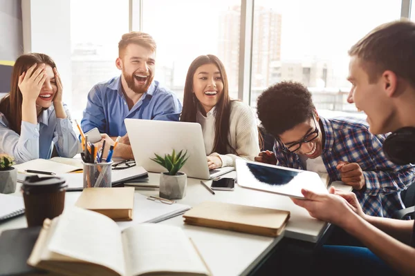 Excited friends having break in college library — Stock Photo, Image