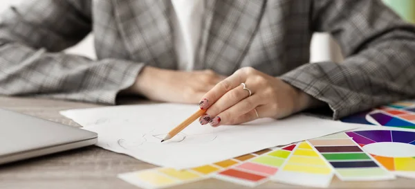 Fashion designer working on drawing sketches for clothes — Stock Photo, Image