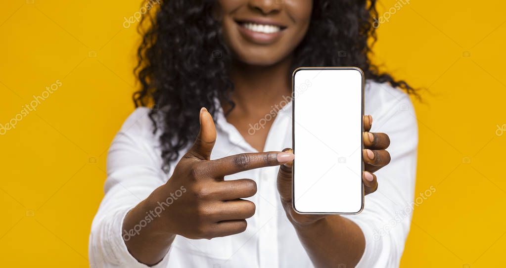 Happy black woman holding latest slim smartphone