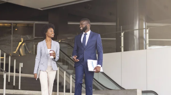 Two african american employees leaving office building for coffee break — Stock Photo, Image