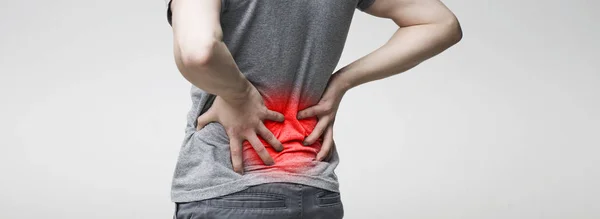 Man holding his hands behind his back, pain in spine — Stock Photo, Image