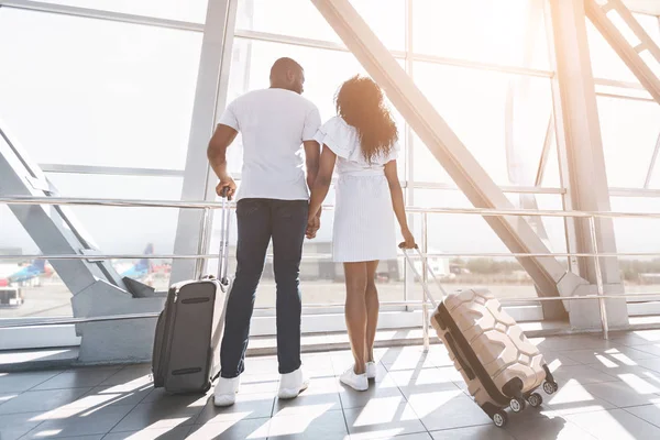 Young black couple enjoying window view in airport building — Stock Photo, Image