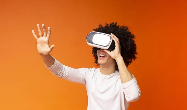 Excited black guy pushing virtual button in VR glasses — Stock Photo, Image