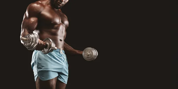 Cropped image of black bodybuilder pumping the iron — Stock Photo, Image