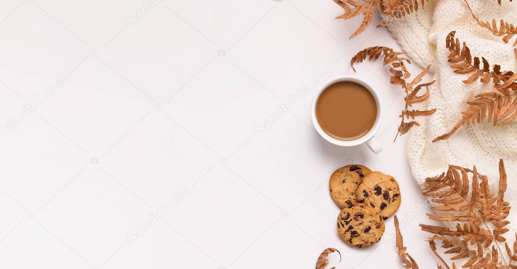 Dry leaves, biscuits and coffee as frame for advertisement on white