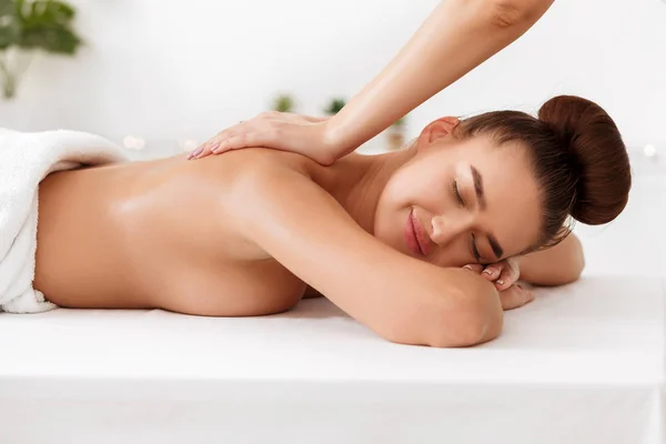 Masseur doet terug massage naar jonge vrouw in Spa Salon — Stockfoto