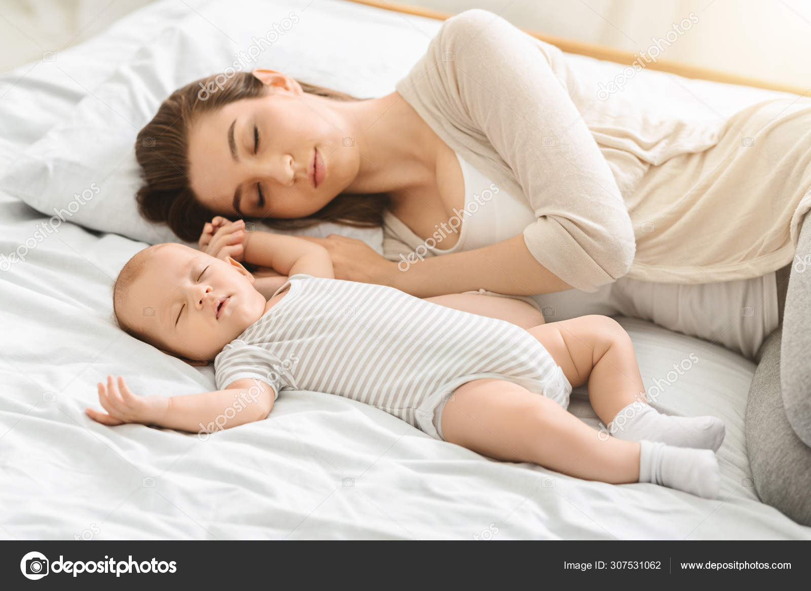Tired mother sleeping with her newborn son, exhausted after babycare Stock  Photo by ©Milkos 307531062
