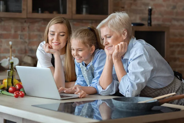 Happy female family looking for recipe on internet — Stock Photo, Image
