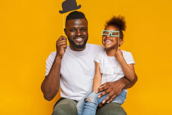 Alegre afro padre e hija posando con accesorios de fotos — Foto de Stock