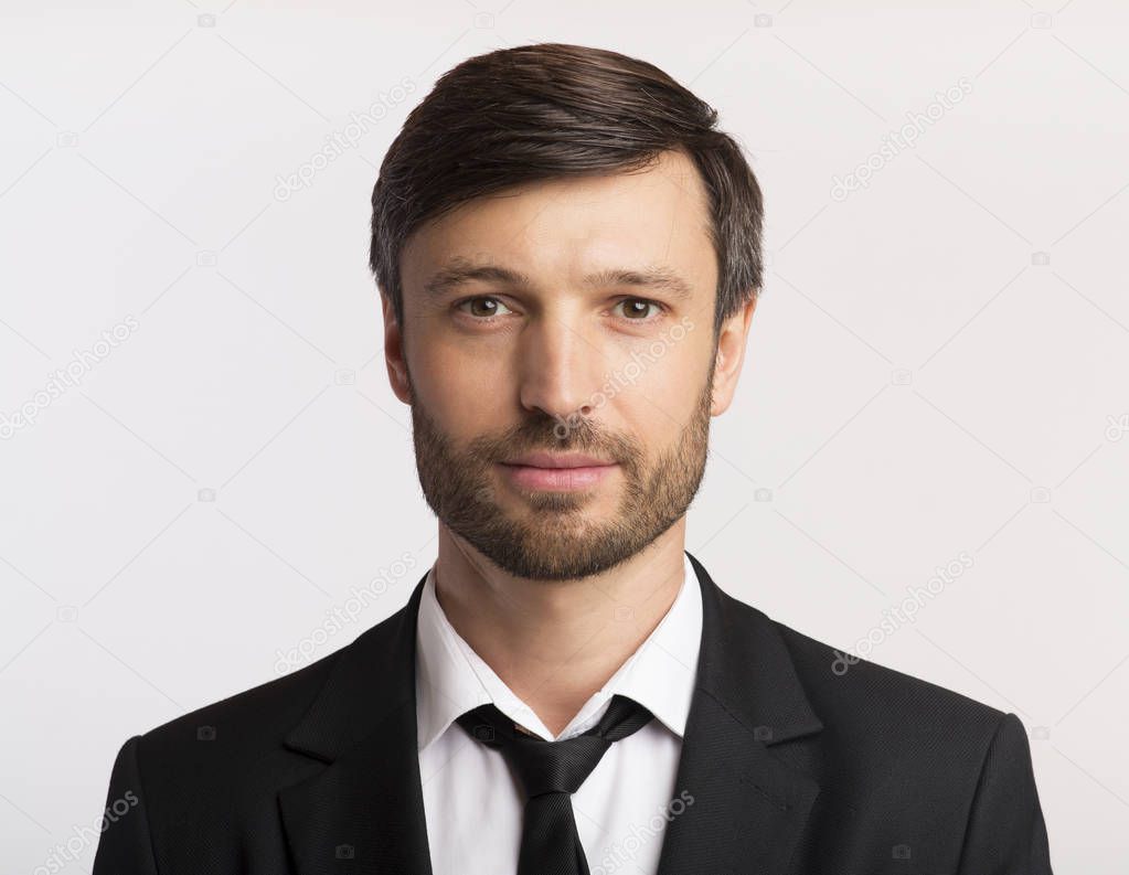 Businessman In Suit Looking At Camera Over White Background, Isolated