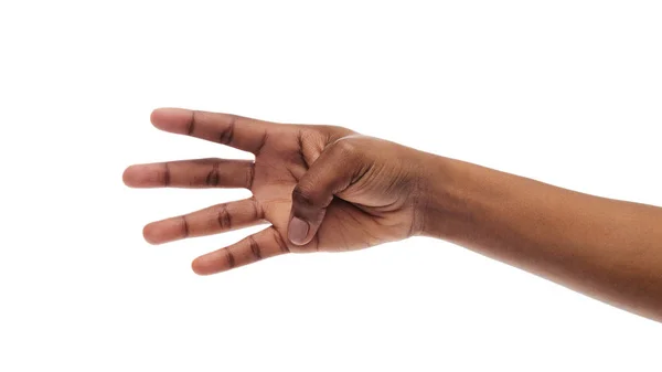 Mano femenina que muestra el número cuatro con los dedos sobre fondo blanco —  Fotos de Stock