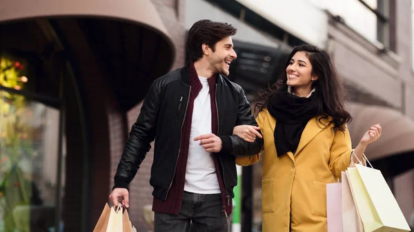 Shopping together. Young couple walking after shopping — Stock Photo, Image
