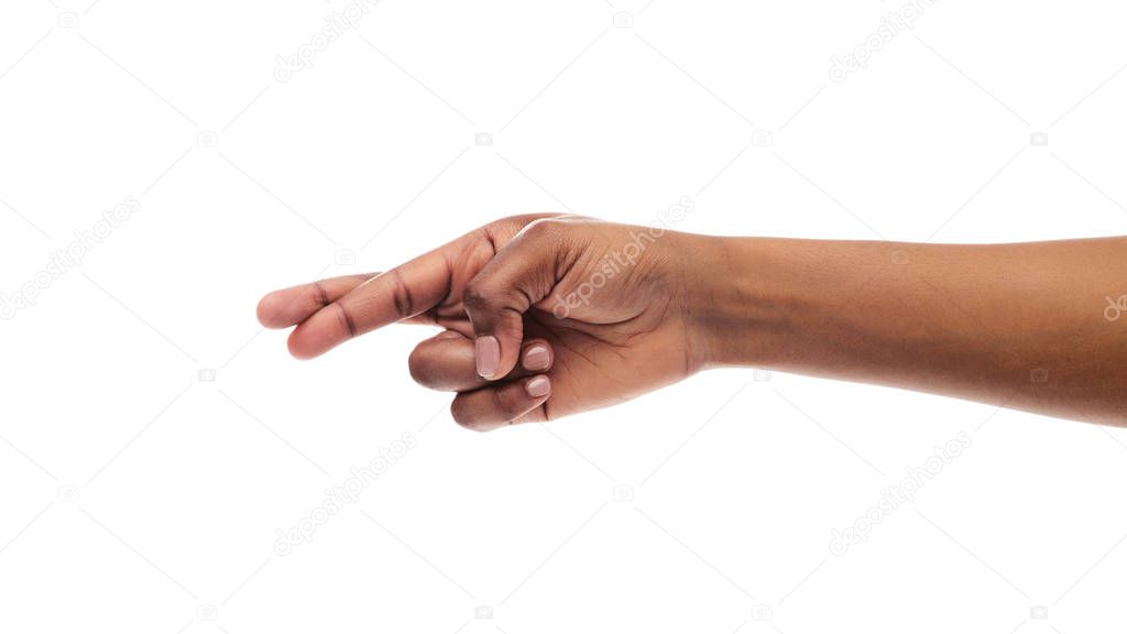 Black womans hand with crossed fingers, isolated on white background