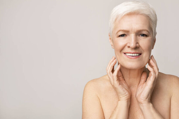 Portrait of attractive senior woman touching her chin