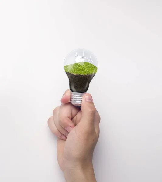 Lightbulb with clean electricity from wind in human hand — Stock Photo, Image