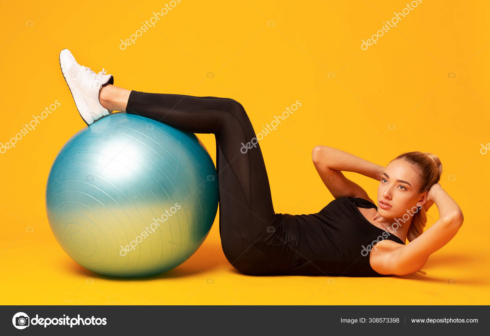 Girl Doing Curl Up With Legs On Fitball In Studio Stock Photo Milkos 308573398