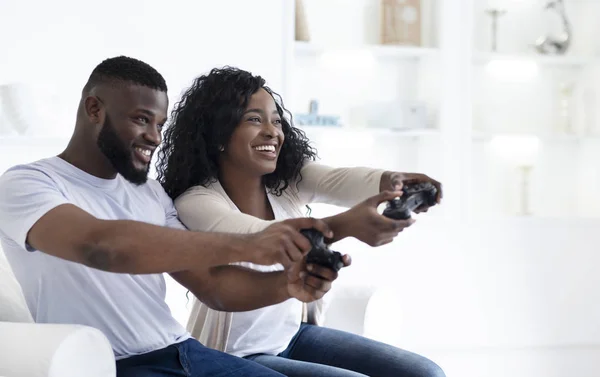 Pareja negra juguetona compitiendo entre sí en un videojuego — Foto de Stock