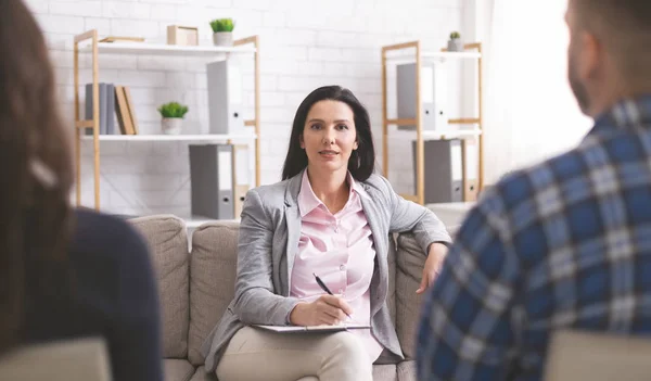 Confident psychologist working at marital therapy session