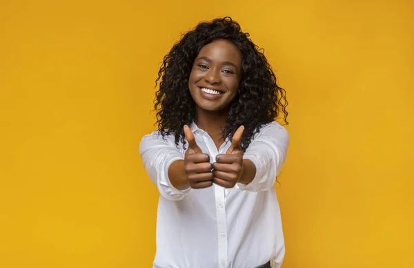 Gelukkige jonge zwarte vrouw die duimen omhoog laat zien — Stockfoto