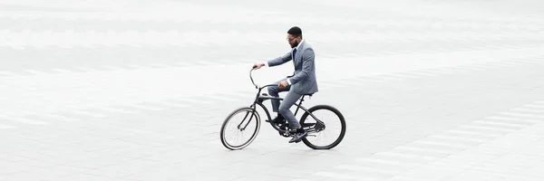 Businessman riding bicycle to work in city center