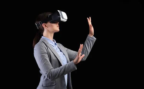 Businesswoman Using VR Headset On Black Background