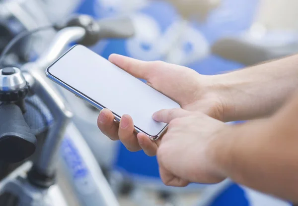 Hombre usando el teléfono celular, alquiler de bicicletas en la aplicación móvil — Foto de Stock