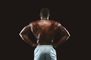 Atletik arka trapezius gösteren Afrikalı-Amerikalı vücut geliştirmeci