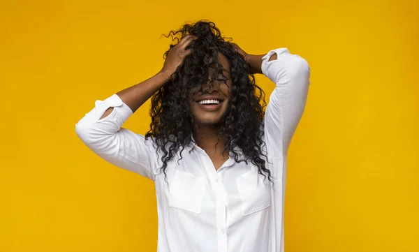 Sexy menina negra sorrindo com os olhos fechados, tocando seu cabelo — Fotografia de Stock