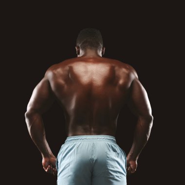 Tanınmaz afro sporcu siyah arka plan üzerinde atletik geri gösteren