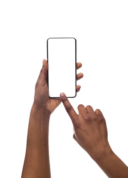 Черные женские руки фотографируют на смартфоне с пустым экраном — стоковое фото