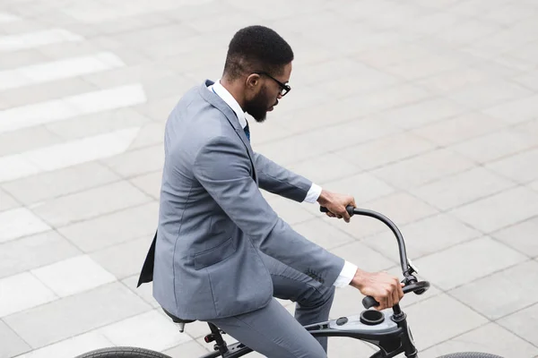 Ativo empresário afro andando para trabalhar de bicicleta — Fotografia de Stock
