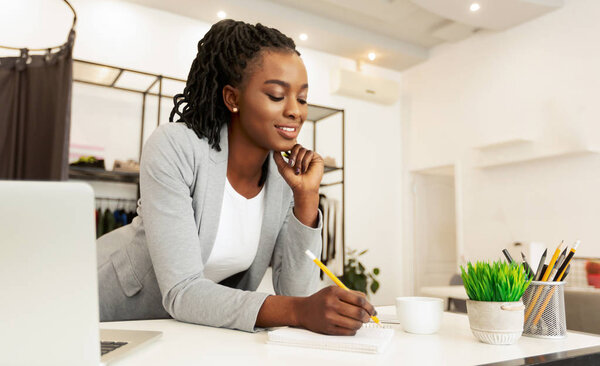 Young Fashion Designer Drawing Sketches At Workplace