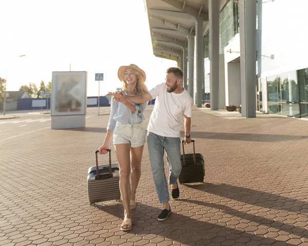People travel. Couple near airport, going on trip