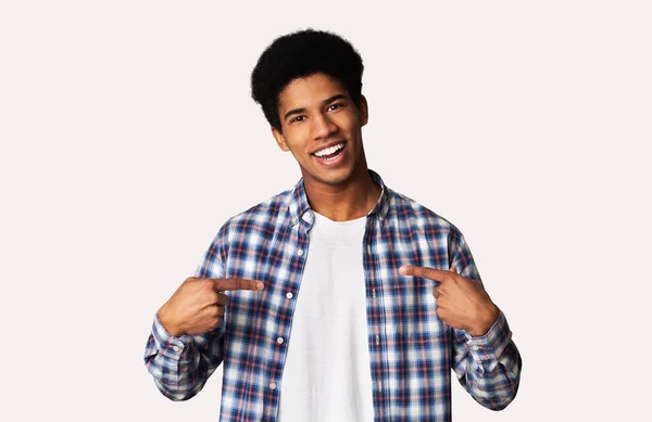 Charismatic black teen guy promoting himself, white background — Stock Photo, Image