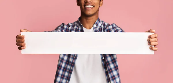 Advertisement concept. Guy holding blank banner for your text — Stock Photo, Image