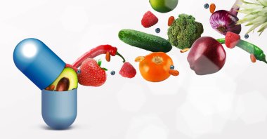 Beyaz arka planda uçan meyve ile Vitamin hapı